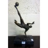 A bronze figure of a footballer, mounted