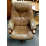A teak and leather swivel armchair