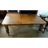 A Victorian oak extending dining table