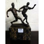 A bronze figure of two footballers, moun