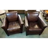 A pair of leather armchairs