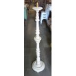 A cream painted standard lamp