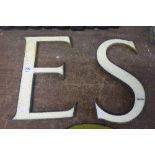 Two cast iron enamelled S and E letters