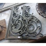 A pair of cast iron brackets