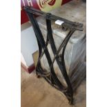 A pair of cast iron sewing table legs