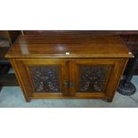 An Edward VII carved walnut two door cupboard