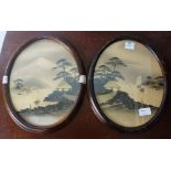 A pair of early 20th century Japanese oval landscape paintings, highlighted in gilt, framed