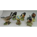 A collection of six Beswick birds; two stonechat, bull finch, whitethroat, goldfinch and blue tit