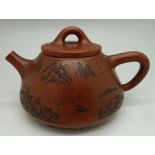 A small terracotta teapot