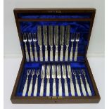 A cased set of twelve dessert knives and forks with mother of pearl handles