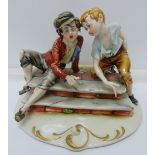 A Capodimonte figure of two boys playing dice, height 13cm