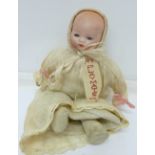 A small doll marked AM, height 20cm