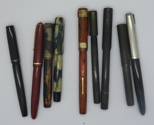 Nine ink pens including Parker, two with matched lids