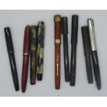 Nine ink pens including Parker, two with matched lids