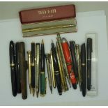 A collection of pens and propelling pencils including Swan and Waterman, two with gold nibs