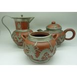A Chinese terracotta and pewter coffee pot, a terracotta and pewter bowl and a pewter teapot,
