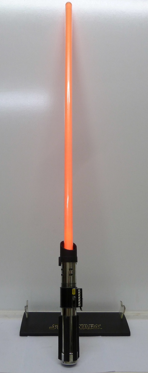 A Hasbro 2007 Star Wars light sabre and stand, in working order, overall length 110cm