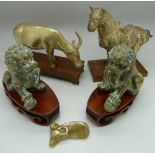 A pair of brass dogs of foe, a brass horse and a brass buffalo, with stands