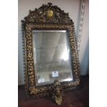 A Victorian Rococo style brass framed mirror