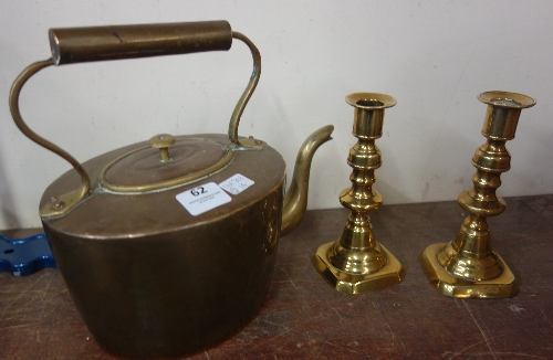 A Victorian brass kettle and a pair of brass candlesticks