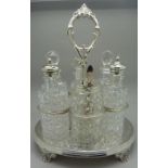 A Victorian six bottle EPNS cruet with fine engraved base and original cut glass bottles,