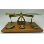 A set of brass postal scales and weights