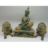 A bronze Far Eastern deity and a pair of bronze temple dogs,