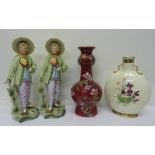 Two bisque figures, a red enamel decorated vase and a moon flask vase, a/f, height of figures 28.