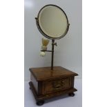 A brass shaving mirror on oak stand