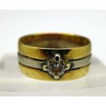 A yellow and white metal ring set with a diamond, weight 4.