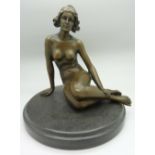 A bronze figure of a lady sitting,