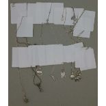 Nine silver pendants and chains