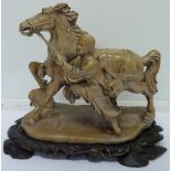 A carved soapstone figure of a horse on stand, height 20.