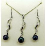 A silver and black pearl pendant and chain with matching earrings