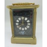 A brass four glass sided carriage clock with enamel dial,