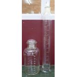 Two chemist's glass measuring jars, heights 53.