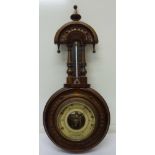 A carved walnut aneroid barometer