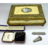 A jewellery box with ivoreen and gilt metal decoration with jewellery including a Scottie dog