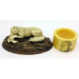 A carved napkin ring and a carved model hunting dog