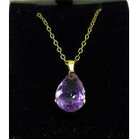 A 9ct gold and amethyst pendant on a rolled gold chain