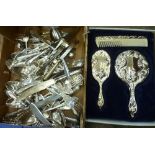 A box of flatware and a vanity set