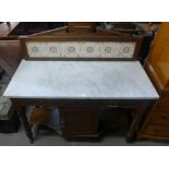 A Victorian walnut and marble topped washstand