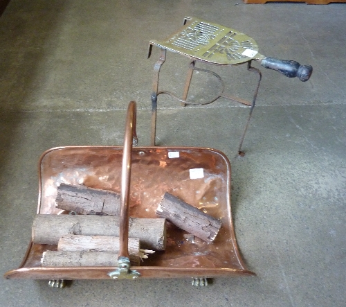 A copper log basket and a brass trivet