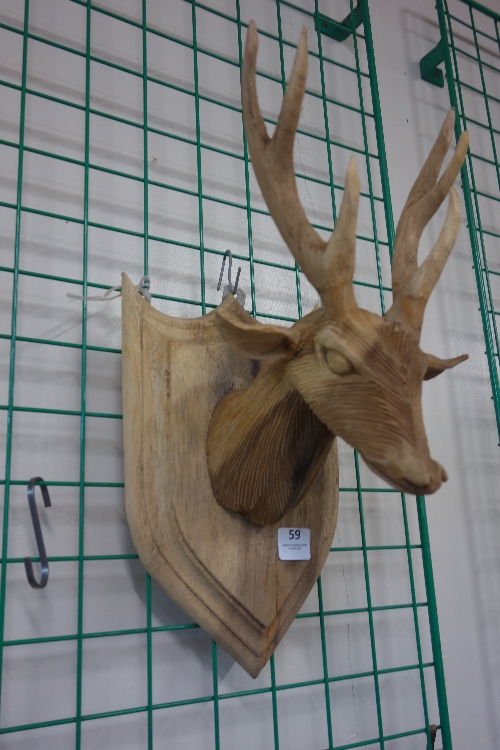 A carved wooden deer's head