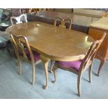 A mahogany extending table and four chairs