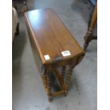 A miniature oak drop-leaf table