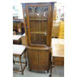 A mahogany freestanding corner cabinet