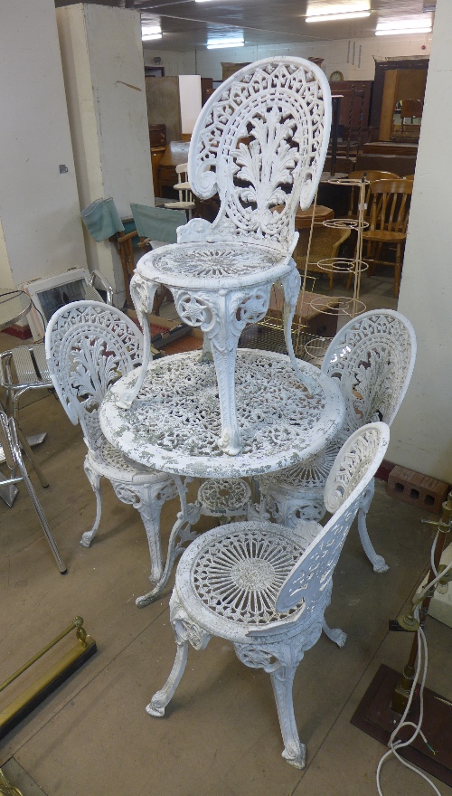 A Victorian style cast metal garden table and four chairs