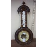 An Edward VII carved mahogany aneroid barometer