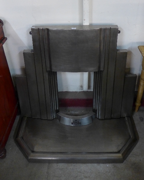 An Art Deco style Jig stainless steel fire surround and hearth